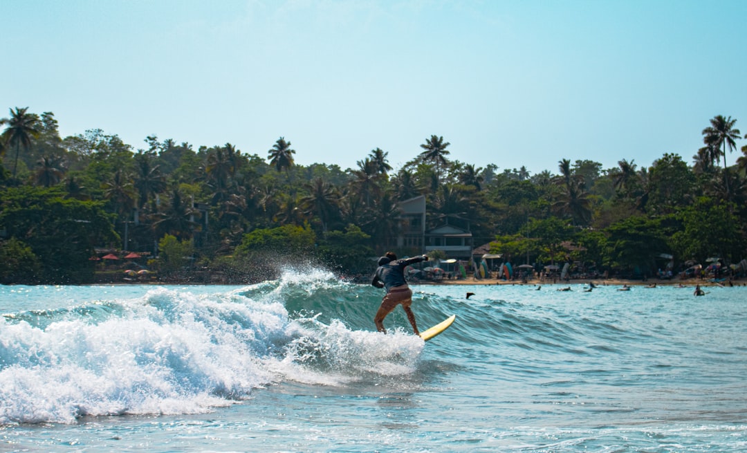 Man surfing a wave in Bali.