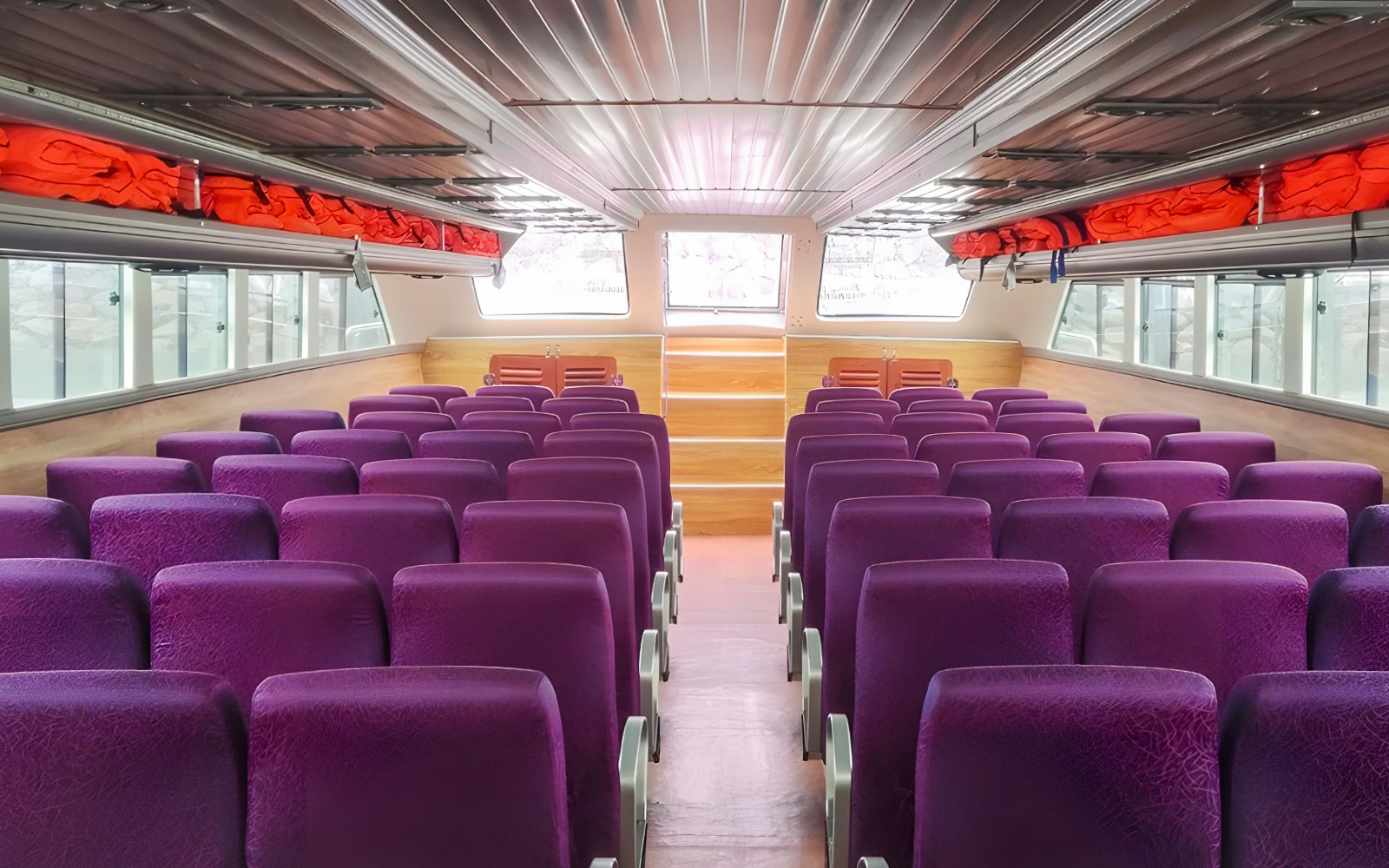 Inside a fast boat cabin showing seats, windows, and visible life jackets - travel photo
